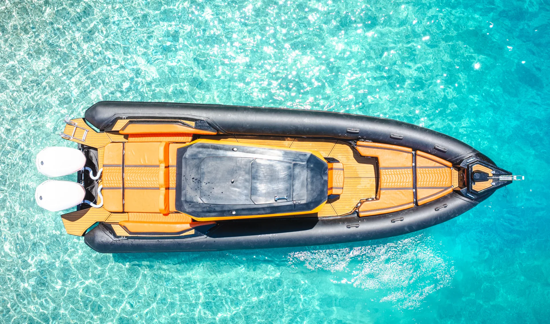 Top-down drone view of the Nemo Boat alone in shallow turquoise water