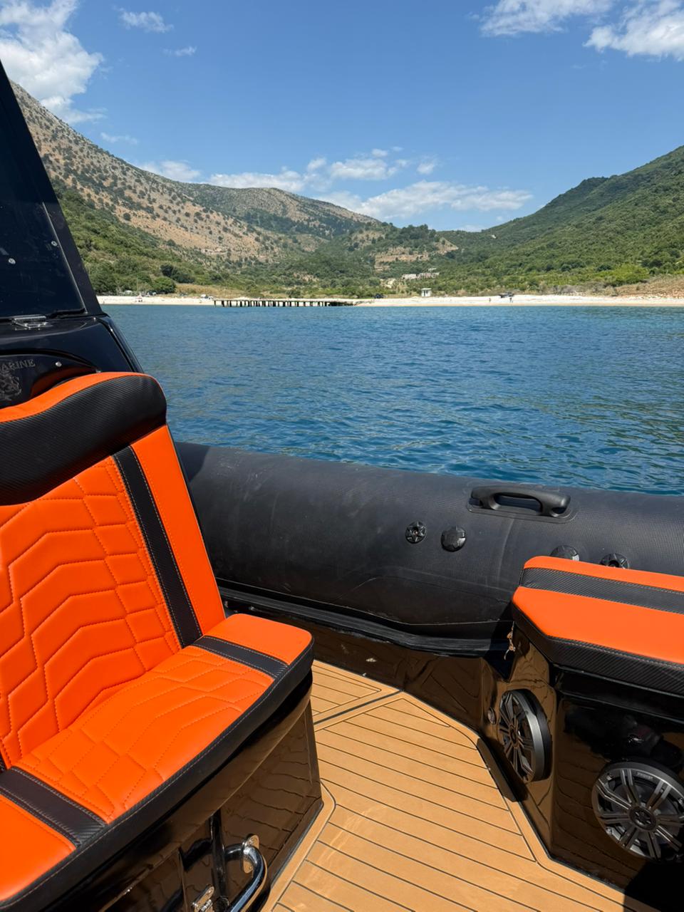 Premium orange quilted seat and teak deck on the Nemo Boat anchored in an Albanian Riviera cove